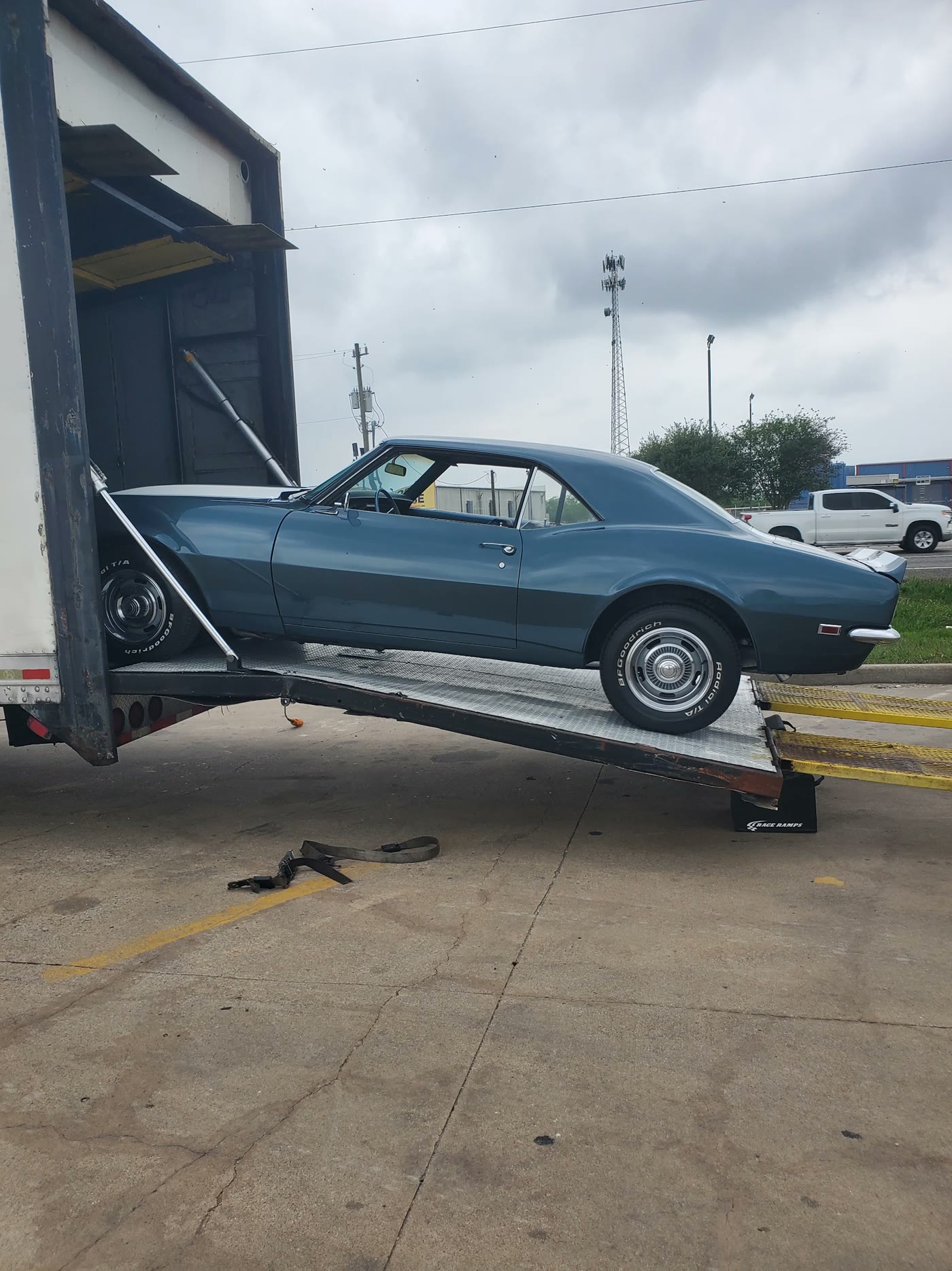 A classic coupe rolling up the ramp into our enclosed trailer